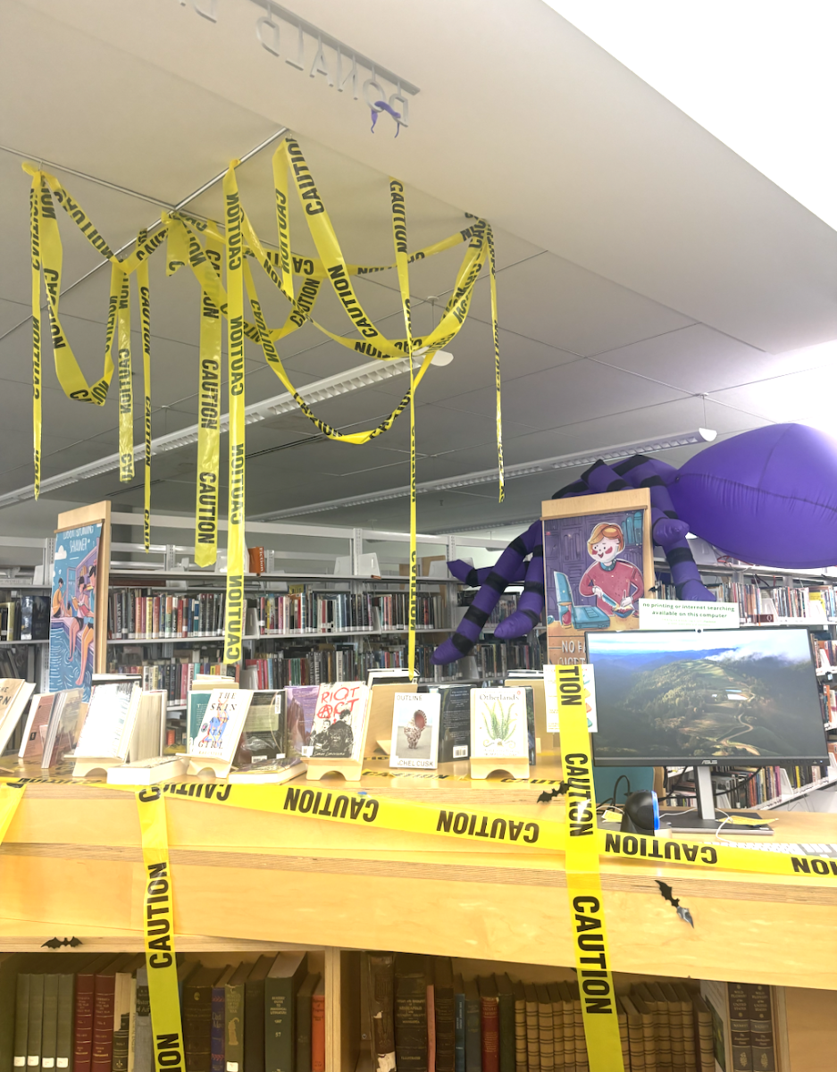 Halloween decorations such as caution tape and an inflatable spider can be spotted around the library during fall.